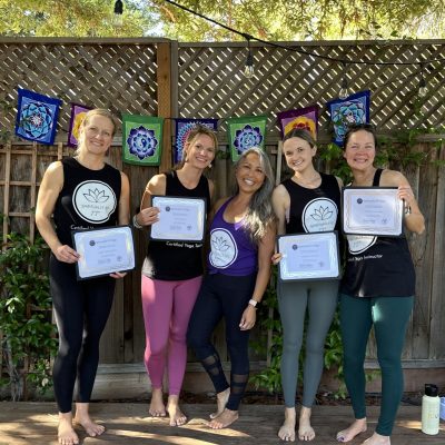 Graduates of a recent Spiritually Fit Yoga, LLC 200-Hour Yoga Teacher Training celebrate certification day on the Yoga Under the Redwoods deck in Danville, California.